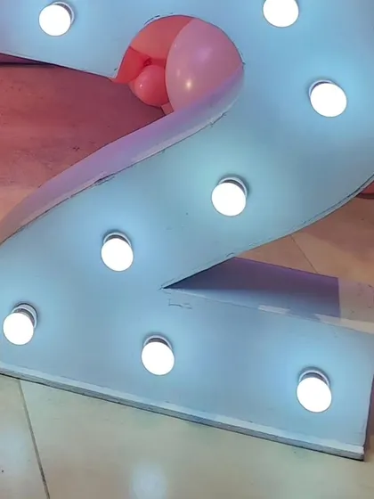 A close-up of the light-up number '2' used in the butterfly-themed birthday party.