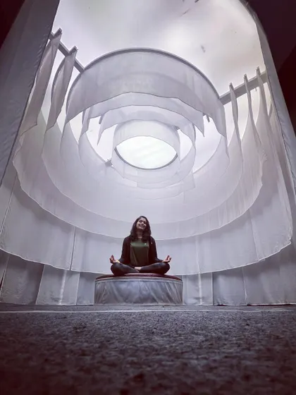 This serene space is perfect for turning inward and focusing on the breath. The seated Gomukhasana pose helps ground your energy while gently working on hip flexibility.