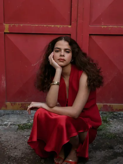 A more intimate, pensive moment from the all-red series. The crouched pose and thoughtful expression add a different emotional layer to the set.