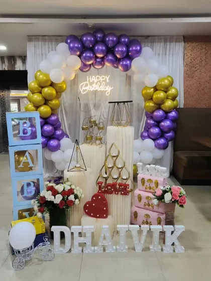 Another view of our popular purple and gold birthday package for 'Dhaivik', showcasing the full arrangement with 'BABY' blocks and decorative props.