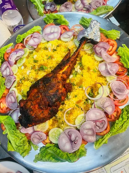 My signature Mutton Mandi platter, featuring a whole leg of lamb slow-cooked until tender, served on a bed of aromatic rice. This is a true centerpiece for a groom's table.
