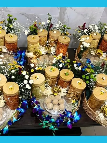 My bestselling winter hamper is perfect for gifting. It includes four varieties of namkeen, homemade Goond ke Laddoos, and fresh flowers, all beautifully arranged in a basket.