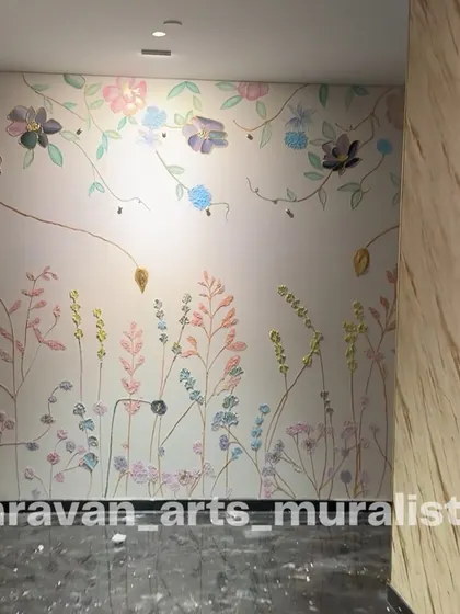 A delicate floral wall mural created with a piping technique in an ultra-luxurious apartment. The pastel-colored flowers seem to grow up the wall, creating a whimsical and artistic feel in the hallway.