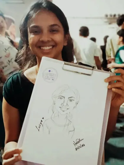 Lasya, happy with her sketch. I can do these portraits very quickly, making it perfect for events with lots of people.