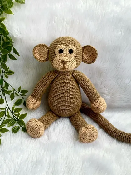 A playful monkey with a long tail, perfect for swinging around. This is my own custom design, and he's ready for lots of jungle adventures.