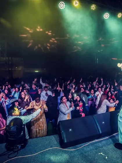 Our lead vocalist connecting with the front row at DKS Club. We love breaking the barrier between the stage and the audience.
