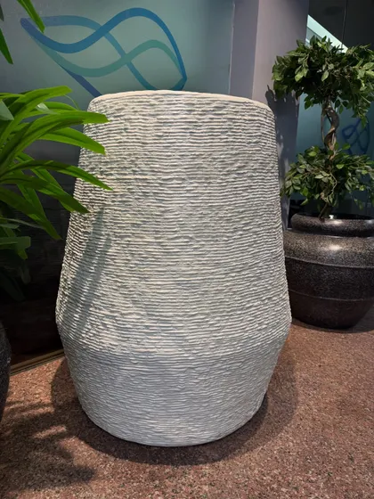 A close-up of one of our white textured planters. The horizontal line detailing adds a subtle design element, making it more than just a pot, but a piece of decor.