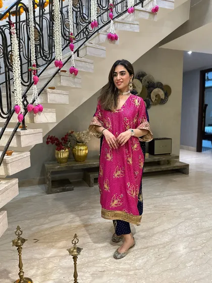 A festive roundup look featuring a bright pink kaftan suit made from a vintage saree. This is a great example of sustainable fashion for Diwali.