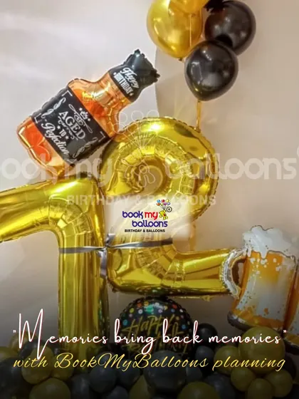 A fun and quirky setup for a 19th birthday. This decor features gold number balloons, a whiskey bottle foil balloon, and beer mug props, making it a playful and memorable way to celebrate entering the last year of one's teens.