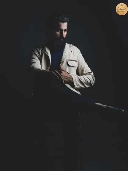 A dramatic, shadowy portrait that creates a sense of mystery and intensity. This style is great for actors looking to showcase their range for more serious roles.