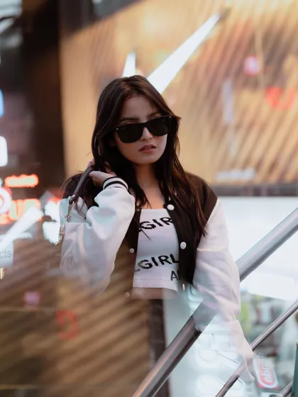 A duplicate of image 40, this night shoot uses city lights to create a cool, edgy street style portrait.