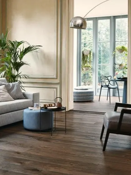 For a sophisticated, classic look, I installed this dark wood flooring. It grounds the room and provides a dramatic contrast to the light walls and furniture, adding a layer of luxury.
