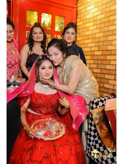 A heartwarming moment as the bride receives blessings from her family during the engagement ceremony.