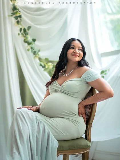 Seated portraits allow for a sense of calm and reflection. The soft green gown and botanical elements create a fresh, serene atmosphere.