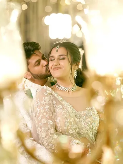 A romantic, dreamy shot of the couple. Her makeup is soft and ethereal, matching the delicate embroidery on her lehenga.