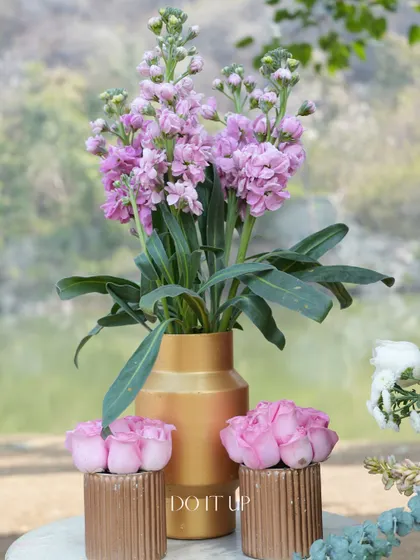 A simple yet elegant arrangement of pink stock flowers in a brass vase. Sometimes, a single type of flower is all you need to make a beautiful statement.