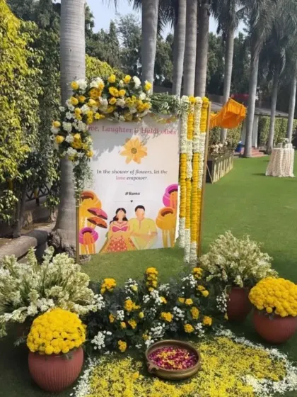 A personalized welcome sign for a Haldi event, decorated with marigold and white flower arrangements. These small details help in creating a customized experience for the couple.