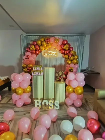 Here is a birthday setup we did at the Ashoka Grand hotel in Shivamogga. The red, pink, and gold balloon arch and the 'BOSS' light-up letters show how we can customize decor for any personality.