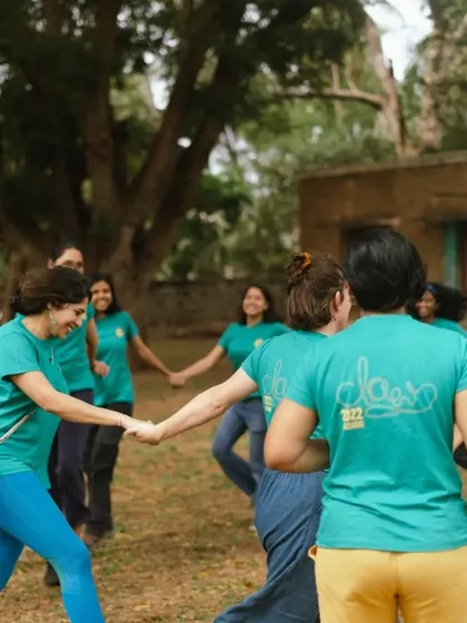 Holding hands and sharing smiles. Our festivals include fun icebreakers and games to help everyone connect and feel part of the community from day one.
