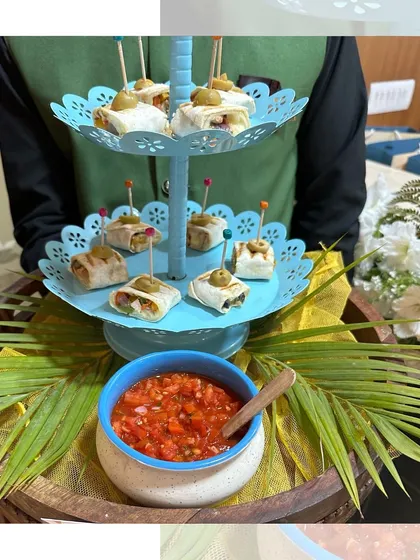 Zesty Fajita Bites served on a tiered stand with a side of fresh salsa. These tortilla roll-ups are a convenient and flavourful party snack.