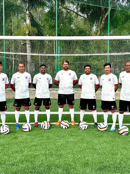 Our full staff team, posing with footballs, ready for the new season.