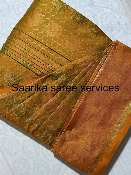 This mustard-colored brocade saree is folded to protect its texture and keep it ready for the next use.