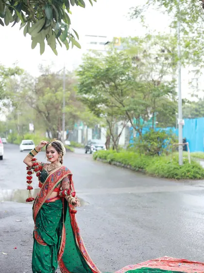 A wide shot showing the bride on a quiet street, her vibrant traditional attire creating a beautiful contrast with the modern setting.