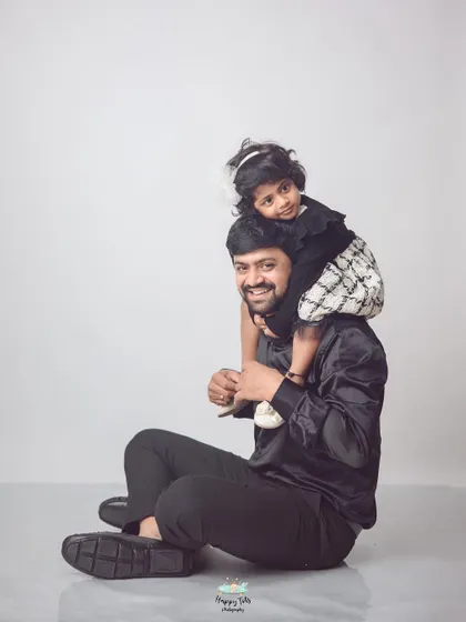 A classic father-daughter shoulder ride. These playful moments make for heartwarming portraits that capture the special bond they share.