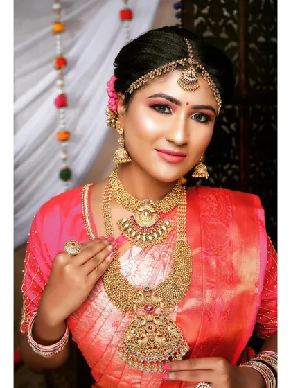 A beautiful bride ready for her big day. She is wearing a layered temple jewellery set with a unique pendant design that adds a personal touch.