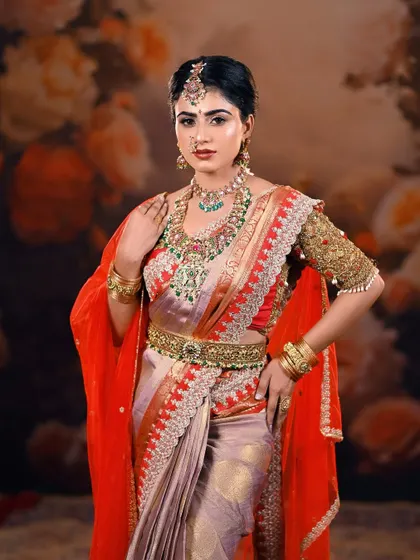A classic bridal portrait pose that exudes grace and confidence. The lighting is carefully set to make the jewellery and the silk saree shine.