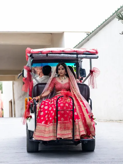 The bride makes a stylish entry in a decorated buggy, a perfect shot for a destination wedding.