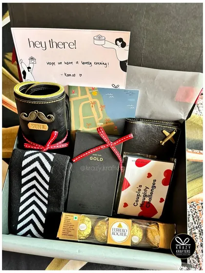 A personalized hamper for him, featuring a custom beer mug, a wallet, naughty couple's challenges, and his favorite chocolates.
