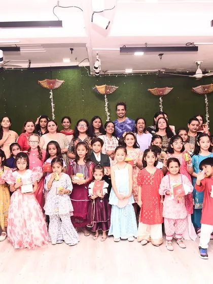 Our little dancers, dressed in their traditional best, holding gifts at the Diwali celebration.