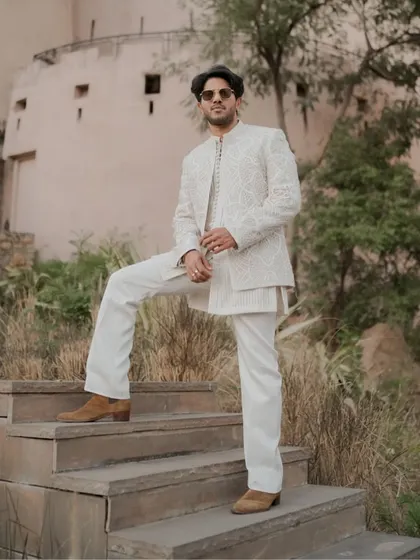 Another angle of Dulquer Salmaan's stunning ethnic wear. The combination of the structured jacket and flowing trousers creates a balanced and powerful silhouette.