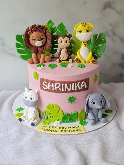 A jungle theme for a jungle princess! This pink cake is decorated with cute, handcrafted jungle animals, making it a sweet and adventurous choice.