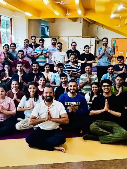 A group photo with MBA students after a successful yoga session. I help future leaders learn to manage stress and maintain balance as they begin their demanding careers.