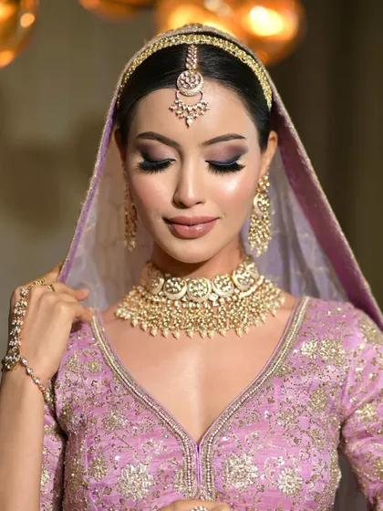 Another angle of this stunning lavender bridal look. The makeup is designed to be both soft and striking.