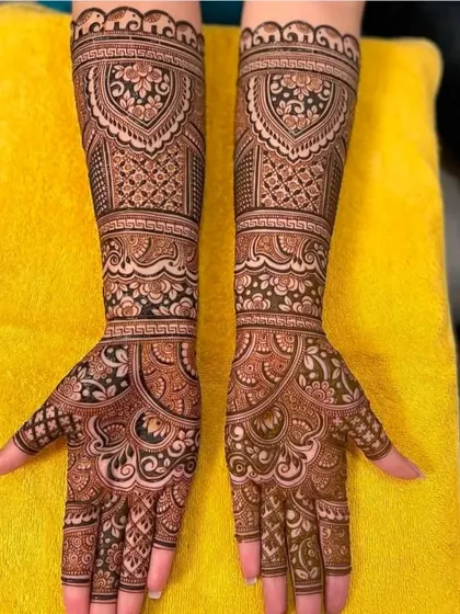 This design features a heart-shaped central motif surrounded by intricate floral and geometric patterns. It's a beautiful and romantic choice for a bride.