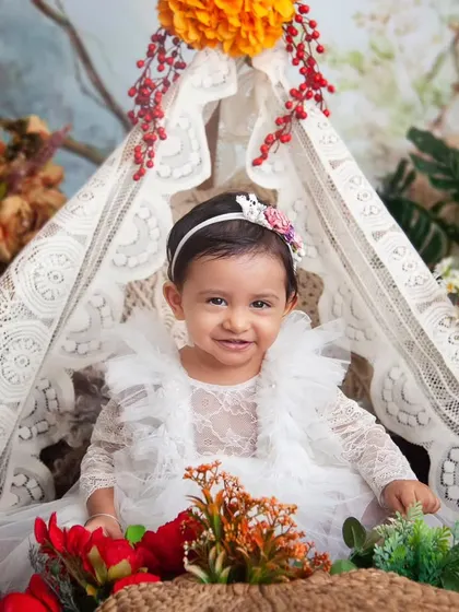 The joy of turning one is written all over her face. This beautiful smile was captured in my popular boho floral teepee setup.