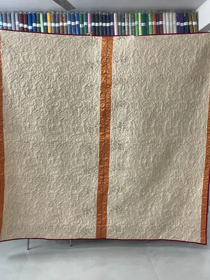 A collection of reversible memory quilts crafted from the sarees of a client's mother. Each side tells a different story, preserving the fabric's patterns and colors in a new, functional form.