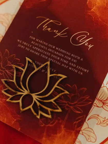 A custom 'Thank You' card with a laser-cut lotus motif, reflecting the wedding's theme. This detail shows how I carry the design language through to the stationery and guest favors.