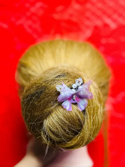 This is the same elegant bun, showing how a small accessory can completely elevate a simple updo. We explore various accessory options in my hairstyling classes.