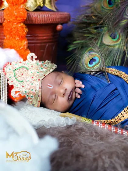A side profile of the sleeping Krishna, showing the intricate details of the setup, including the crown and jewelry.