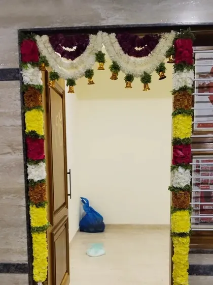 A 'double pardha' or double-layer toran design for a doorway. The bells add a lovely traditional sound to the decor.