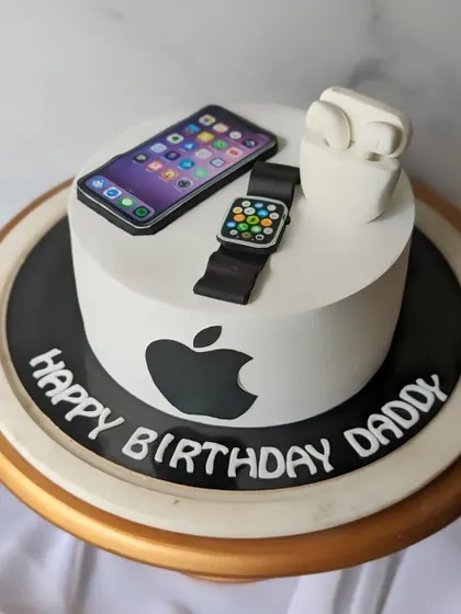 For the ultimate Apple fan. This cake is decorated with a fondant iPhone, Apple Watch, and AirPods, all sitting on top of the iconic Apple logo.