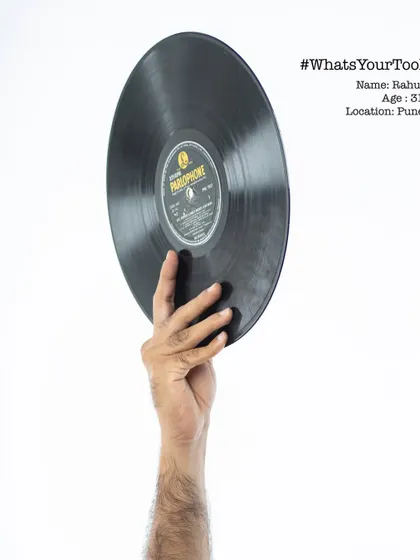 Rahul, a 31-year-old DJ, holding a vinyl record. The "What's Your Tool" series was a personal project to give a glimpse into the hands responsible for the work we see and hear every day.
