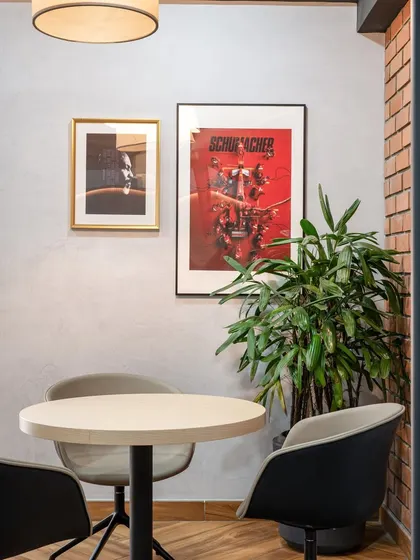 A small discussion room with movie and racing-themed posters. This space shows how even the smallest rooms can be infused with personality and brand character.
