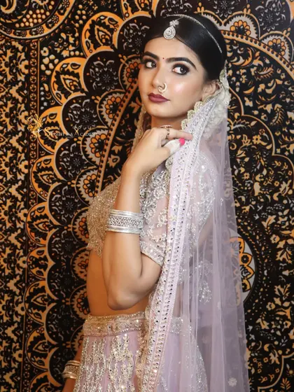 A beautiful shot of our pastel bride against a traditional backdrop. The contrast highlights the modern elegance of her look.