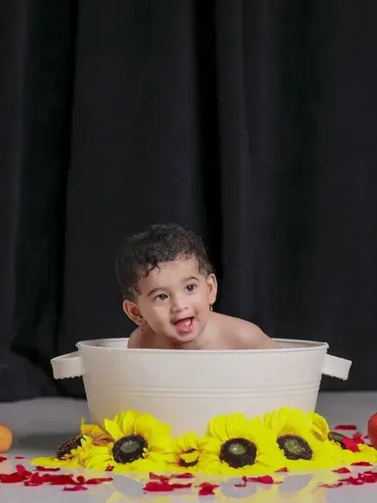 Tub time cuteness overload. A simple setup with a black backdrop makes the joy pop.