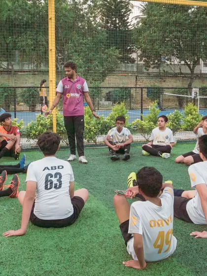 A post-training debrief session. We believe reflection is a crucial part of growth, where players and coaches discuss the session's learnings to ensure continuous improvement.